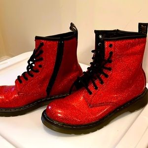 Dr. Martens orange glossy lace up combat boots.